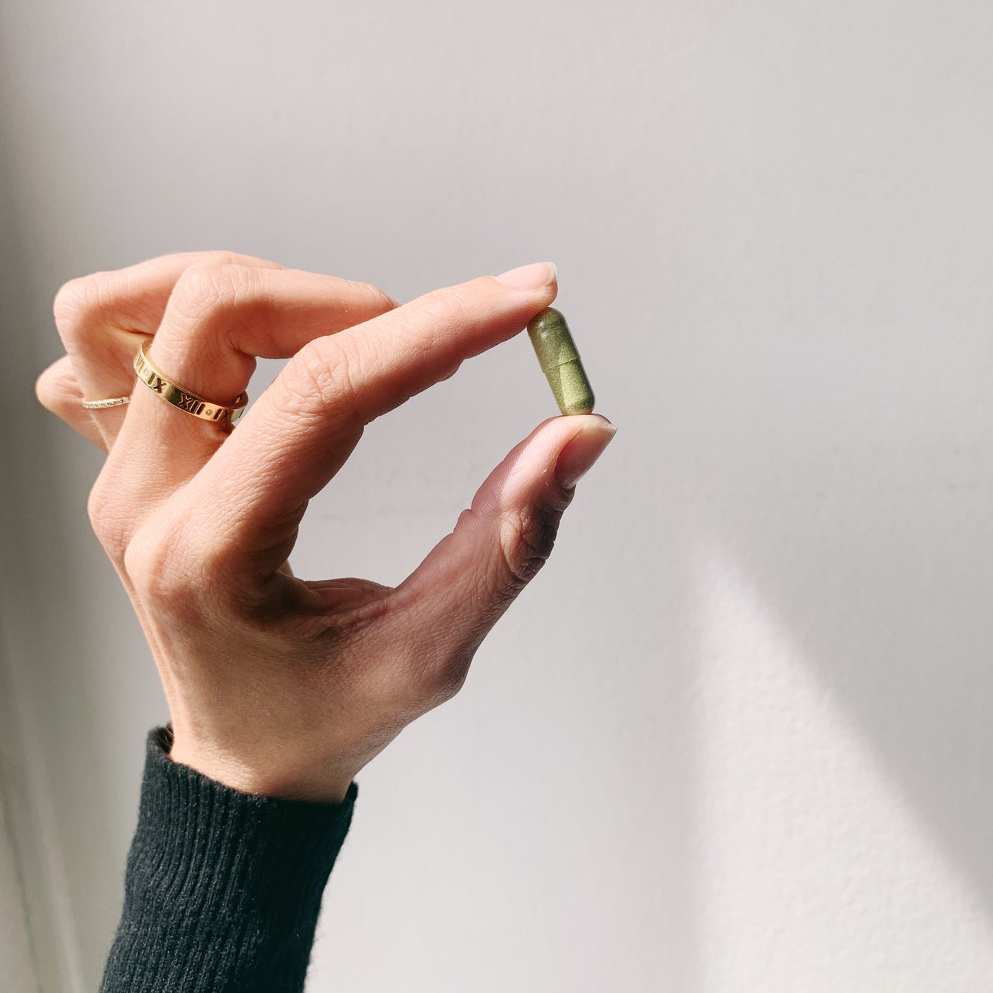 Customer holding Lucidia supplement capsule — daily wellness routine