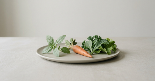 Matte ceramic plate with fresh herbs, kale, and carrot in soft natural tones