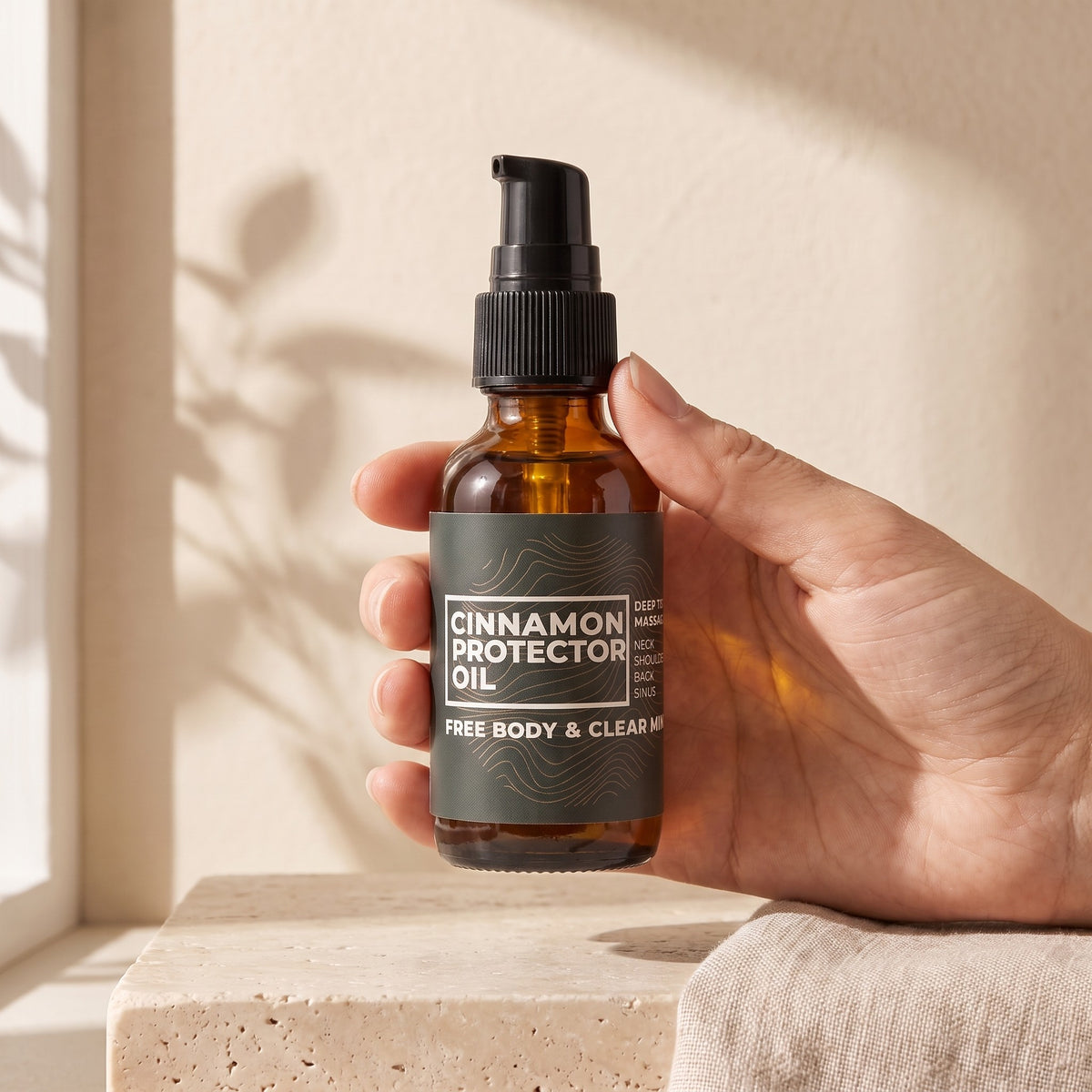 Cinnamon Protector Oil held in one hand, showing the 1 fl oz size