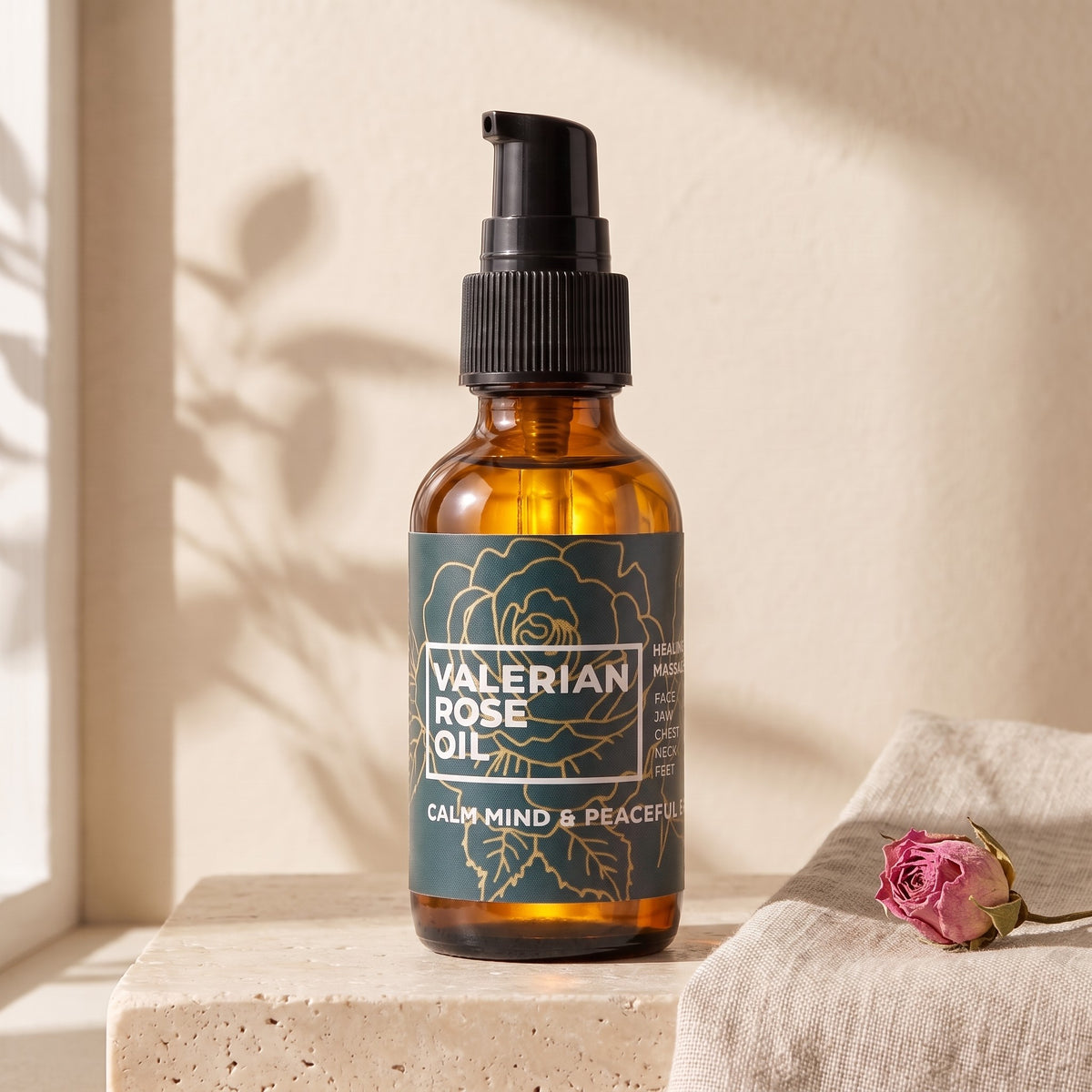Valerian Rose Oil pump bottle on a travertine ledge in morning sun
